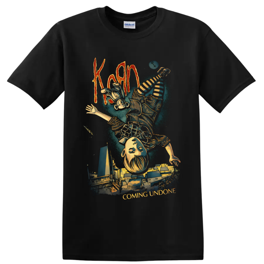 Korn Coming Undone art with upside-down striped figure and surreal cityscape on a Black T Shirt
