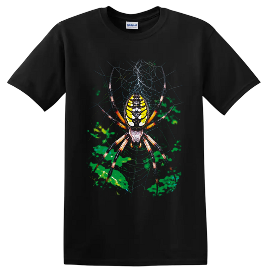 Colorful orb weaver spider with yellow abdomen on a detailed web and green foliage on a Black T Shirt