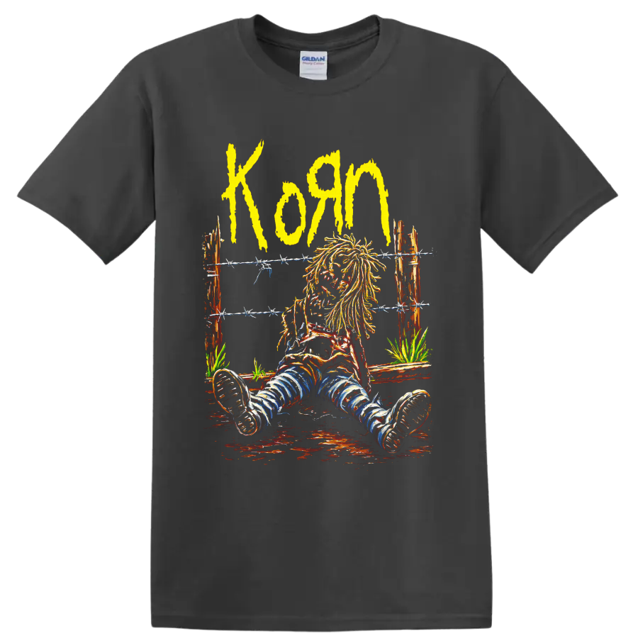 Korn yellow wordmark and seated long-haired figure behind barbed wire on a Charcoal T Shirt