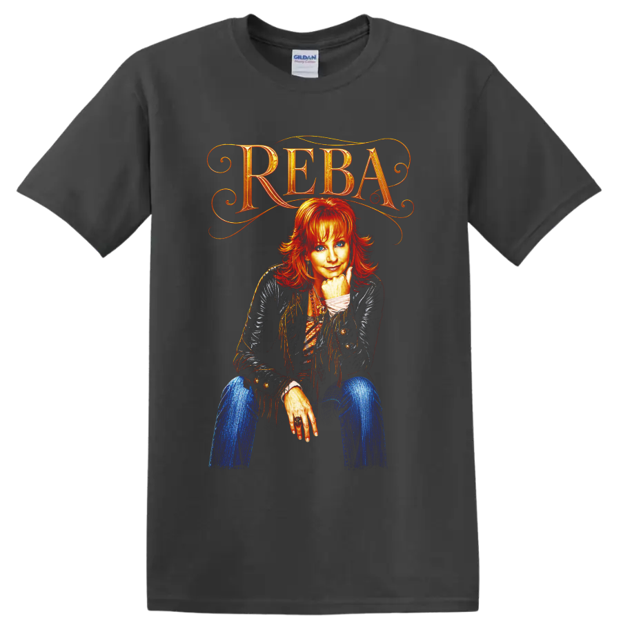 Reba McEntire portrait with ornate REBA lettering, fringe jacket, and vivid western art on a Charcoal T Shirt