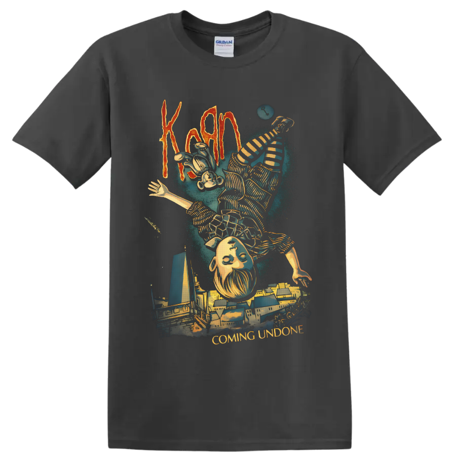 Korn Coming Undone art with upside-down striped figure and surreal cityscape on a Charcoal T Shirt
