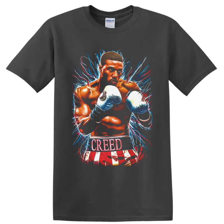 Adonis Creed boxing illustration with blue gloves, paint bursts, and CREED text on a Charcoal T Shirt