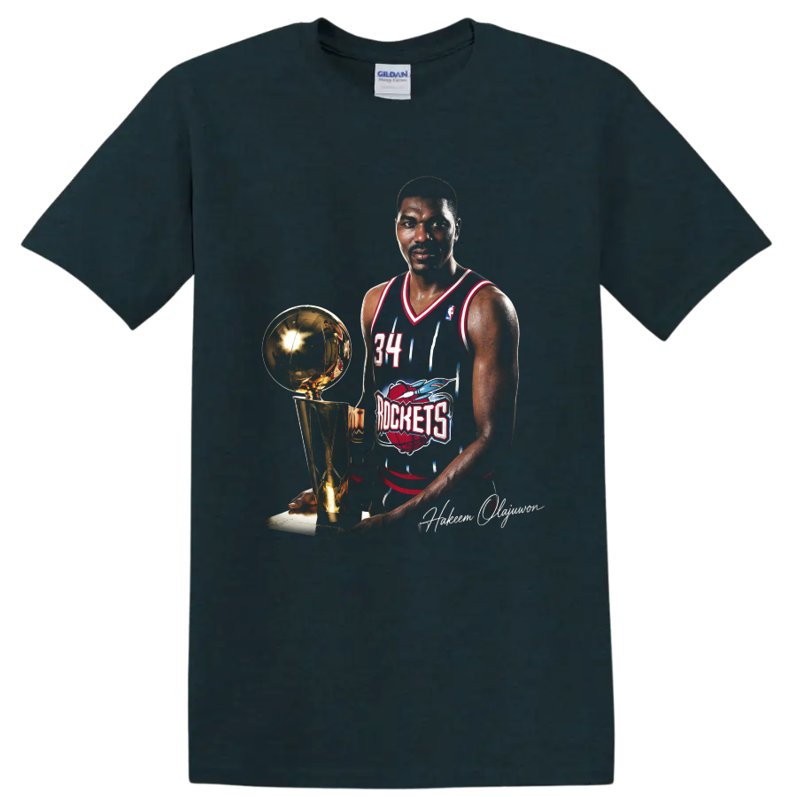 Hakeem Olajuwon in Houston Rockets No. 34 uniform beside championship trophy on a Midnight (Green) T Shirt