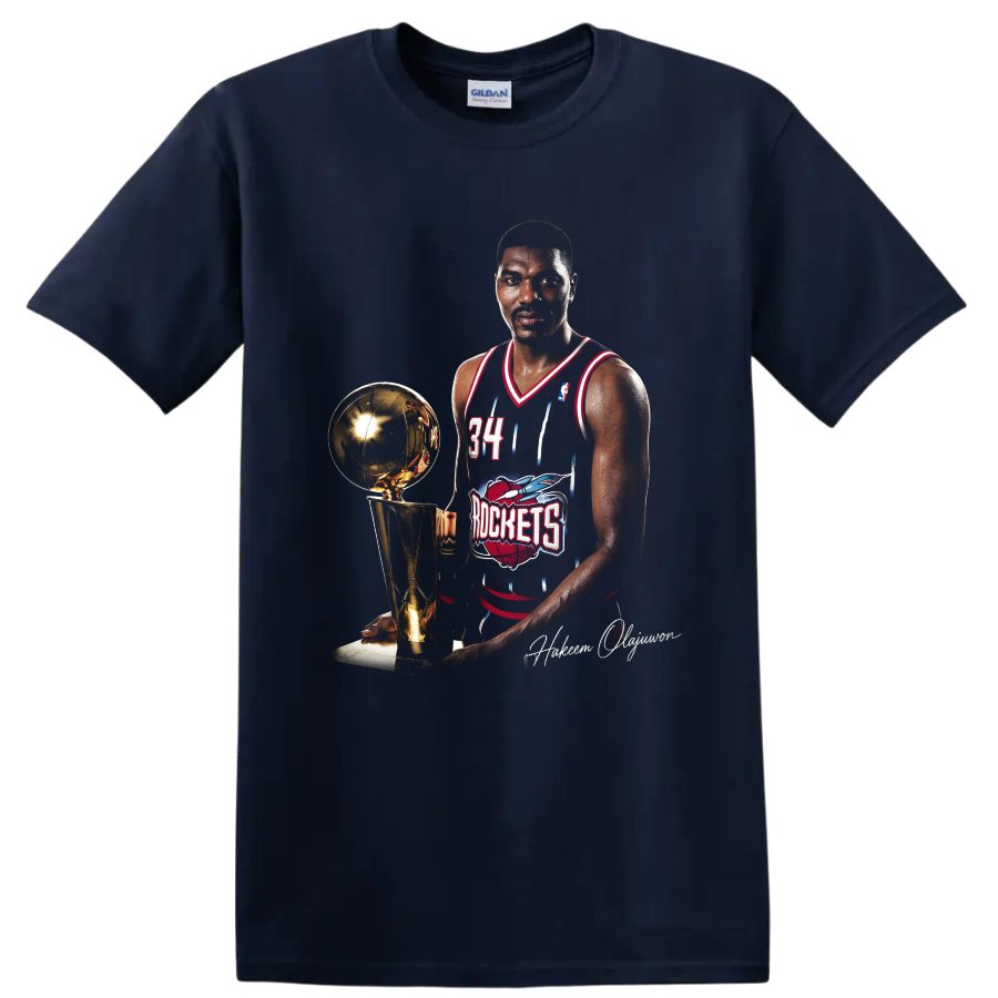 Hakeem Olajuwon in Houston Rockets No. 34 uniform beside championship trophy on a Navy (Blue) T Shirt