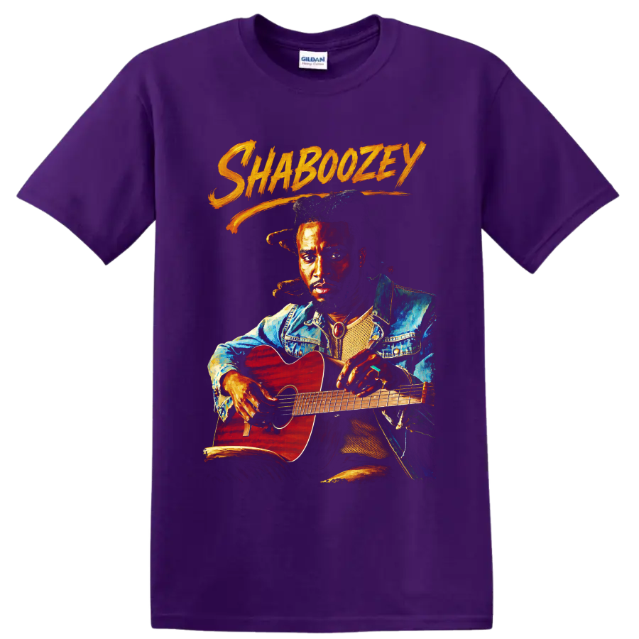 Painted Shaboozey portrait holding a red acoustic guitar with orange brush lettering on a Purple T Shirt